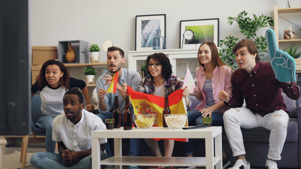 a group of people sitting on a couch watching TV