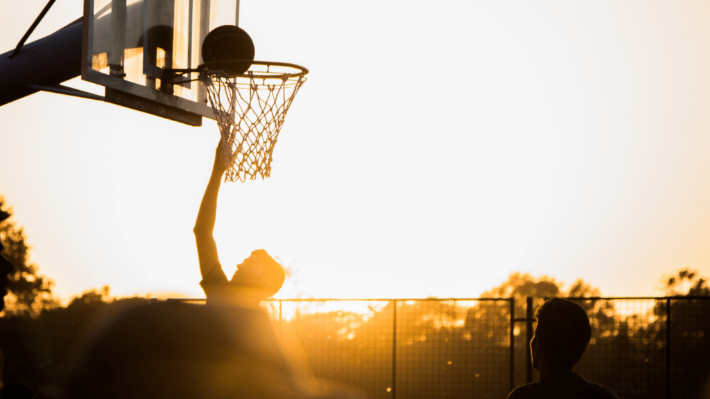 A person is holding up a basketball 