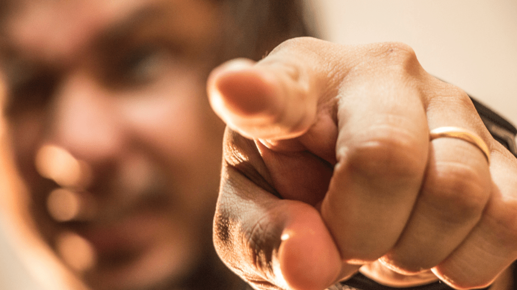 a close up of a person pointing at something