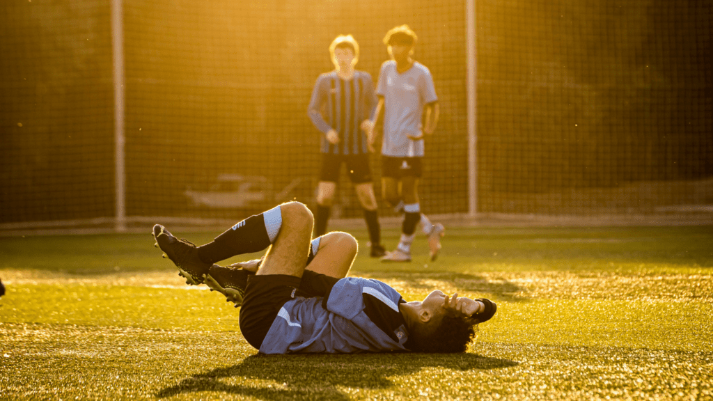 Soccer player laying on the ground