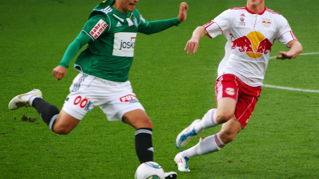 two soccer players in action on the field