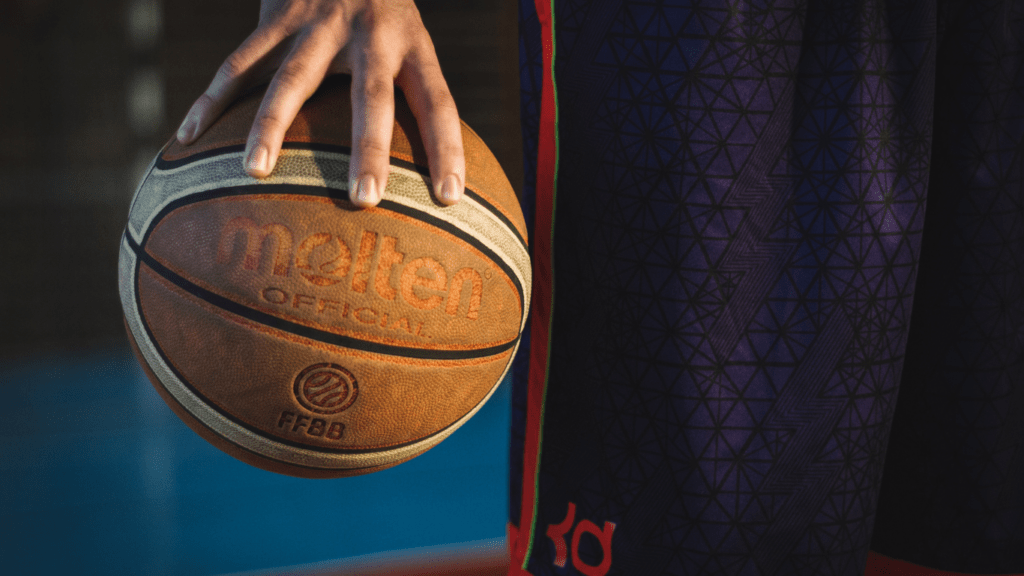 a close up of a person holding a basketball