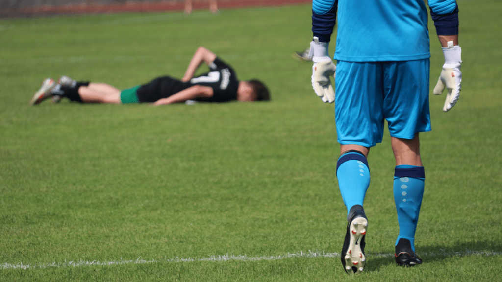 Soccer player laying on the ground