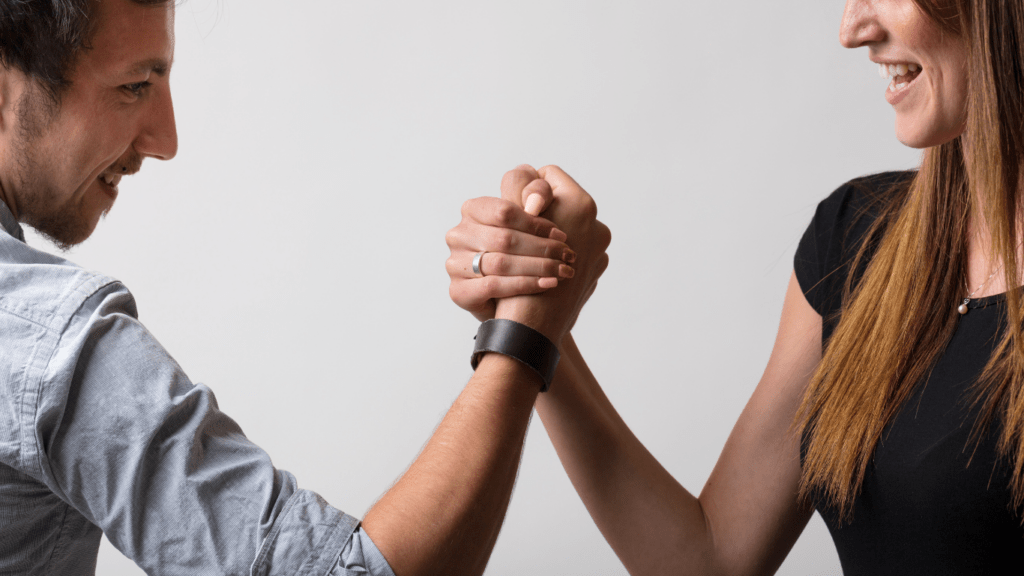 two people are arm wrestling