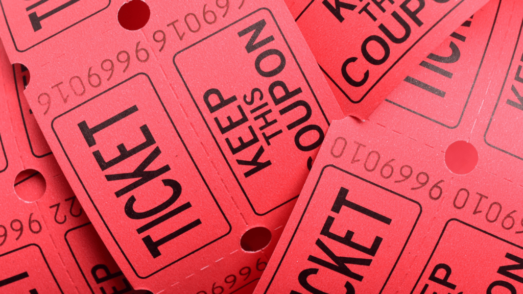 a pile of red tickets with black writing on them