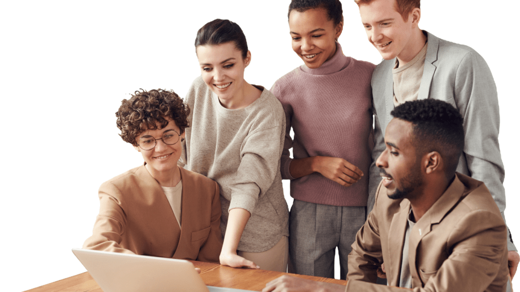 a group of people sitting around a table with a laptop