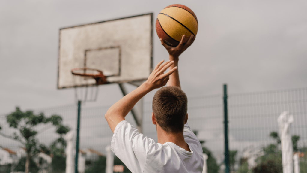 A person is holding up a basketball