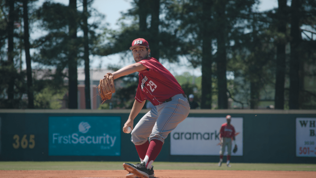 a baseball pitcher throwing the ball during a game