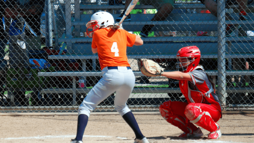 a baseball player swinging at a pitch 