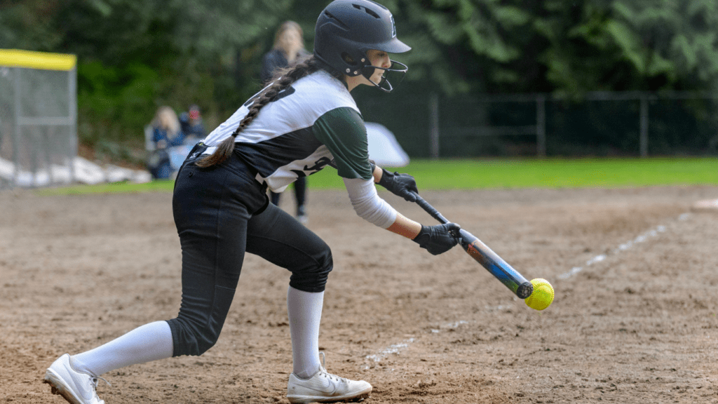 a baseball player swings at a pitch during a game