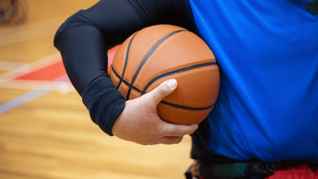 a close up of a person holding a basketball