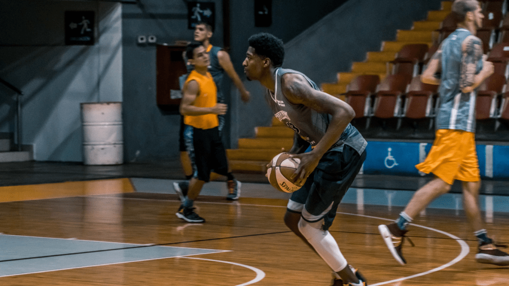 a group of people playing basketball in a gymnasium