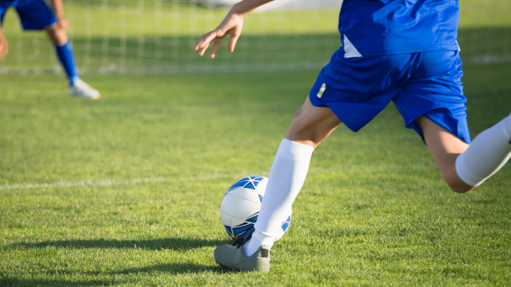 a person kicking a soccer ball