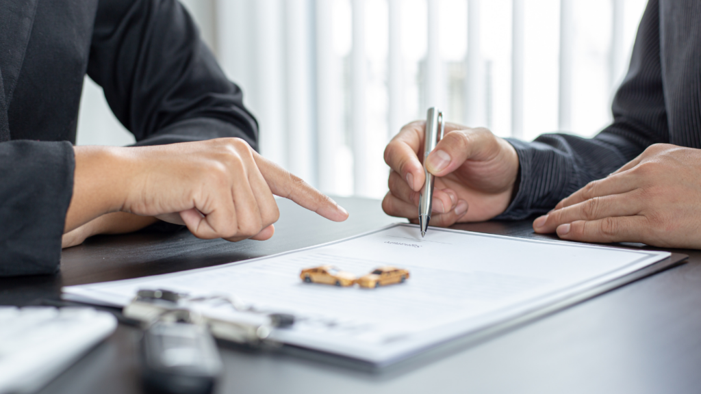 a person signing a mortgage documen