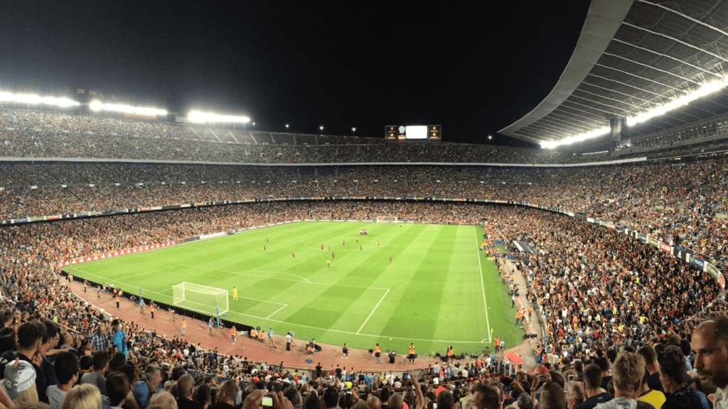 a soccer stadium full of people watching a game