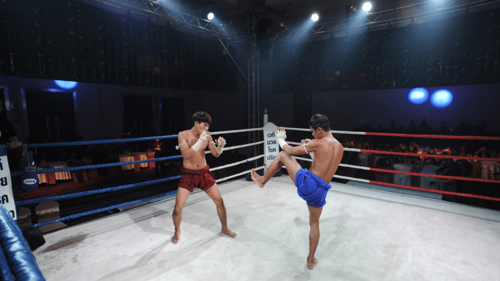 two muay thai fighters fighting in an arena