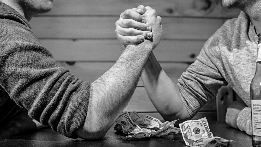 two people are arm wrestling