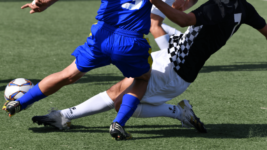 two soccer players in action on the field