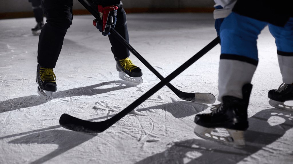 two young playing hockey on an ice rink